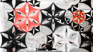 A group of snowflake shaped separators hanging from the ceiling of a building