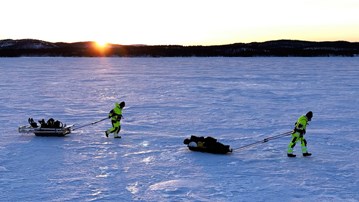 Three researchers walking over a frozen fjord in the documentary "Fjords Frontiers: Digging into the future of climate change".