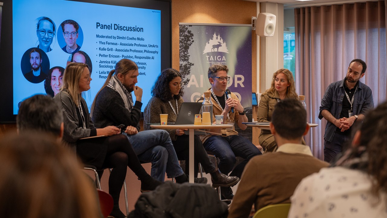 6 people in a panel discussion in front of an audience