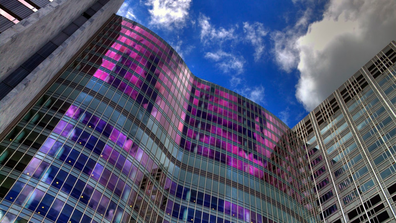 High-rise buildings where the sky is colourfully reflected in the façade.