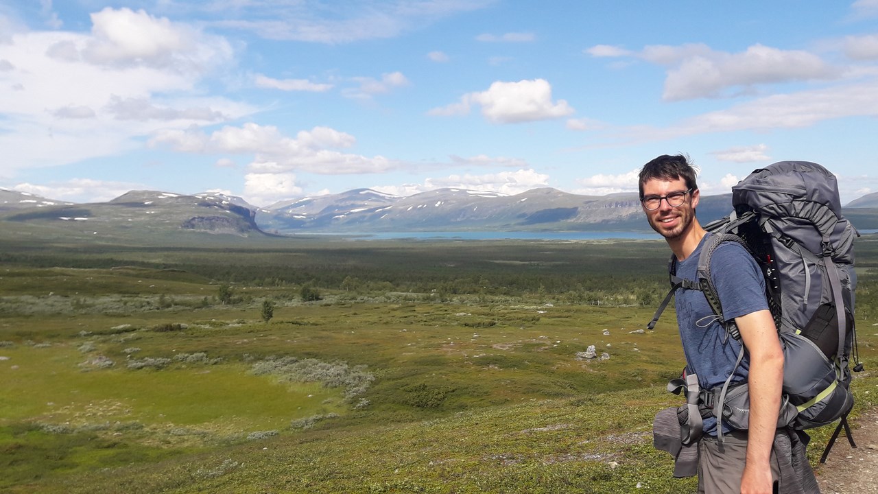 Adrien Heymans, 'EC' postdoktor i öppet landskap med berg i bakgrunden