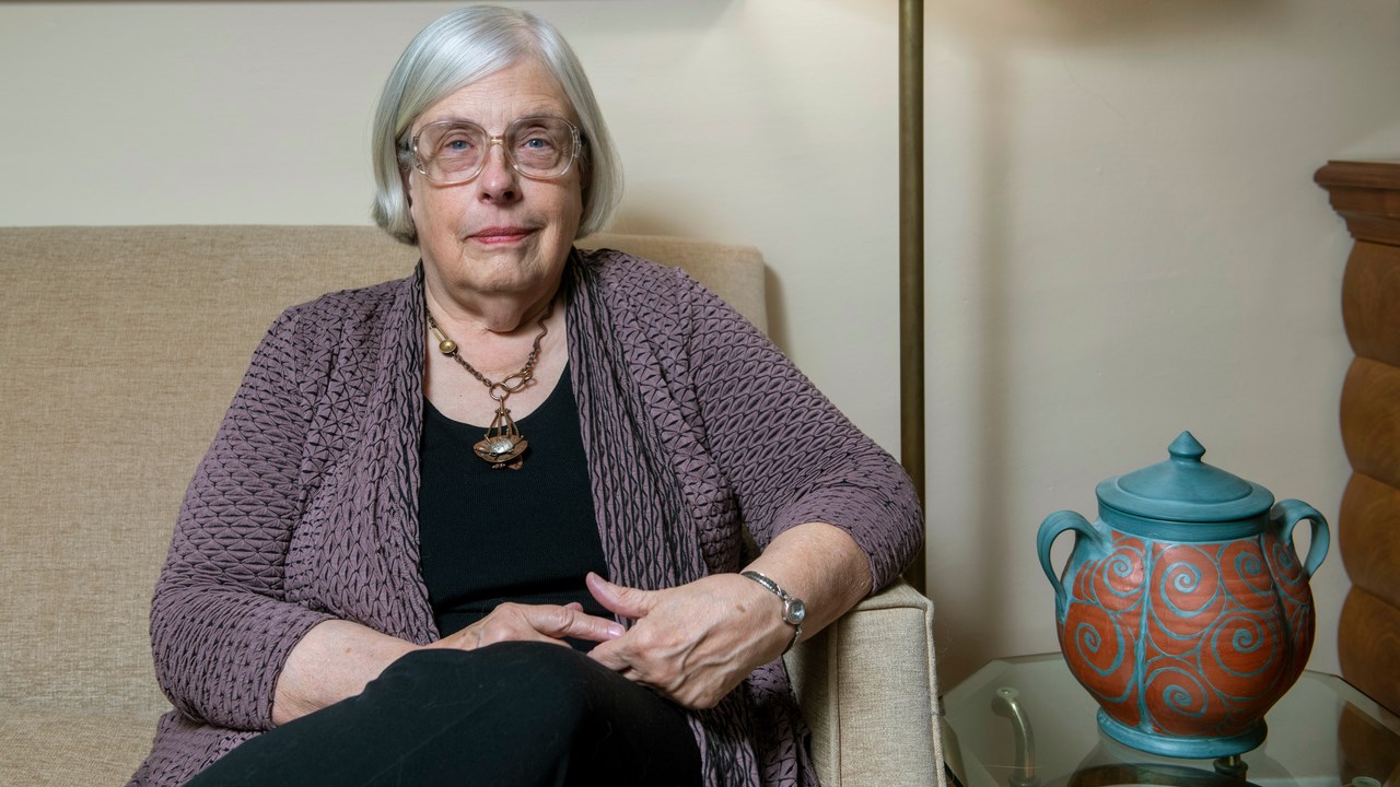 Professor Theda Skocpol sitting in a sofa in her living room 