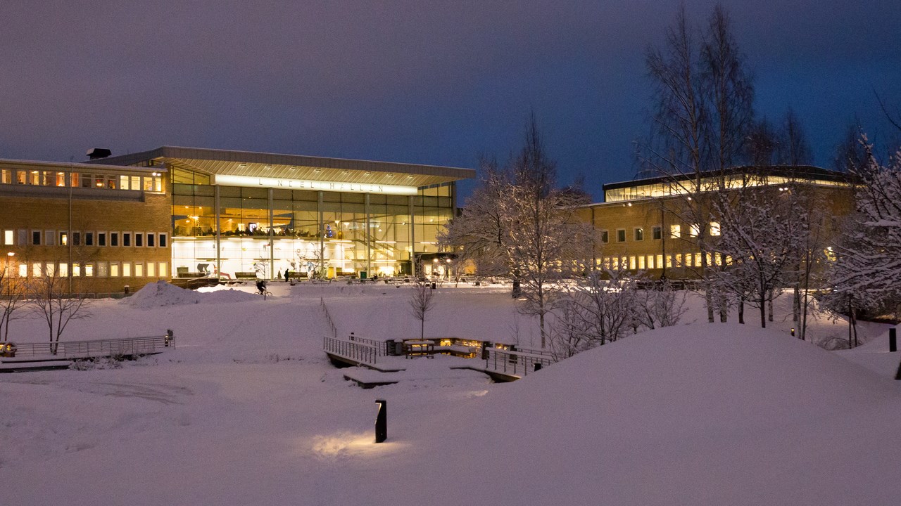 A view of a snow covered campus in the twilight of winter.