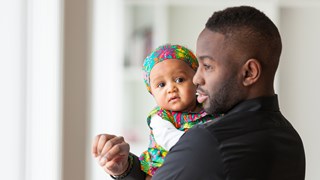 A man holding a baby.