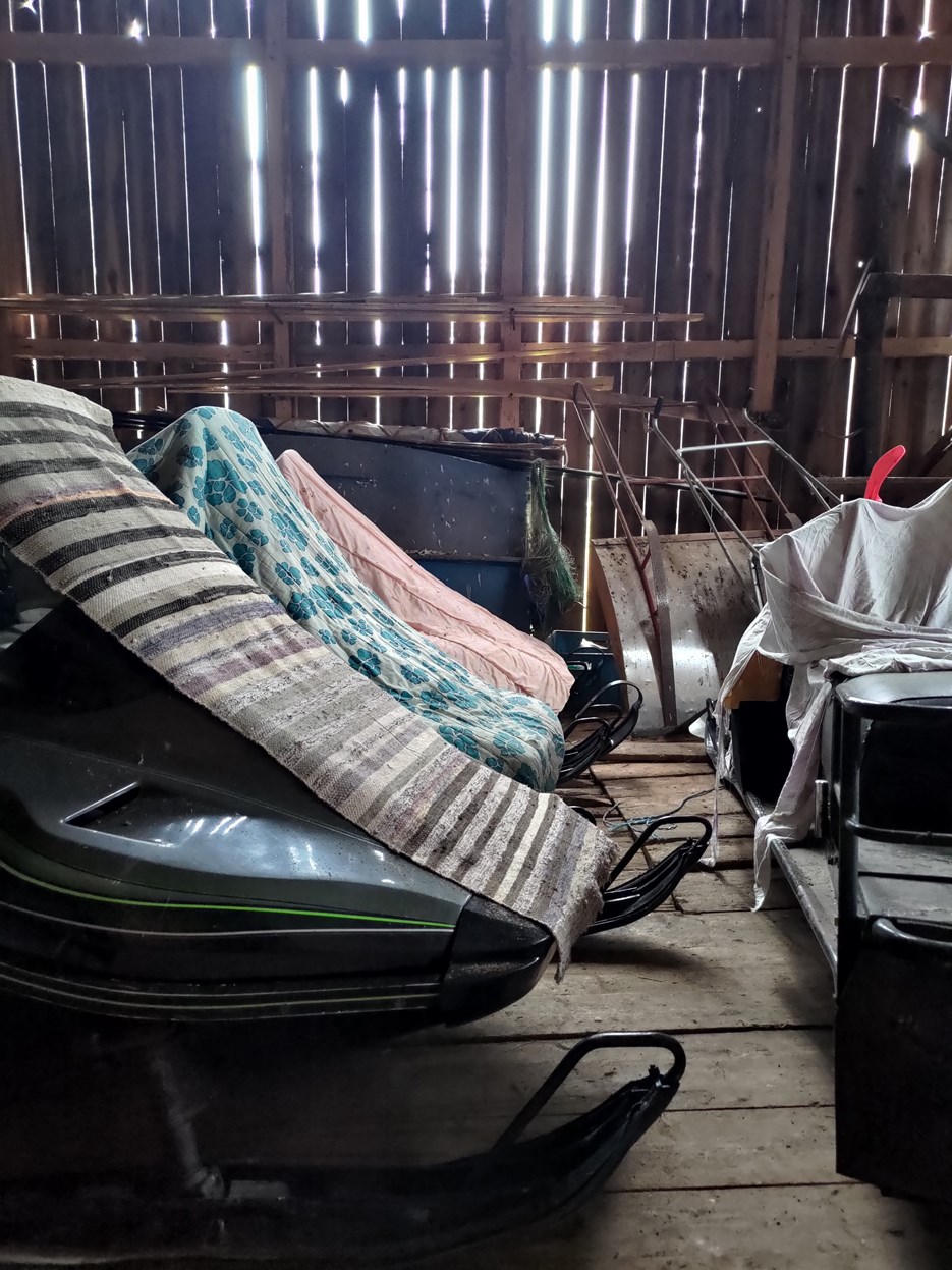 Storage of snow mobiles with hand woven rugs on top