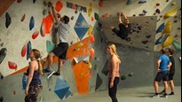 Climbing wall with people around