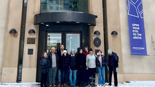 Doctoral students stand in front of Arktikum entrance