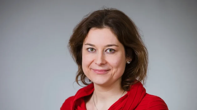 Portrait of a woman in a red shirt.