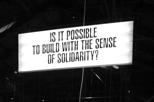 sign with text "is it possible to build with the sense of solidarity?"