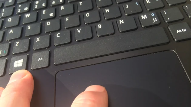 Fingers on top of a zoomed-in keyboard.