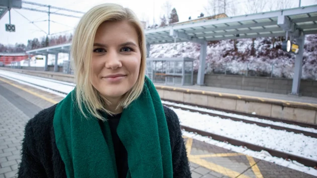 A girl standing on a train platform