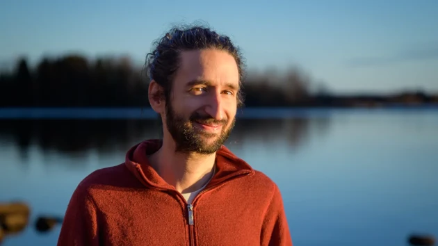 A man standing in front of a body of water