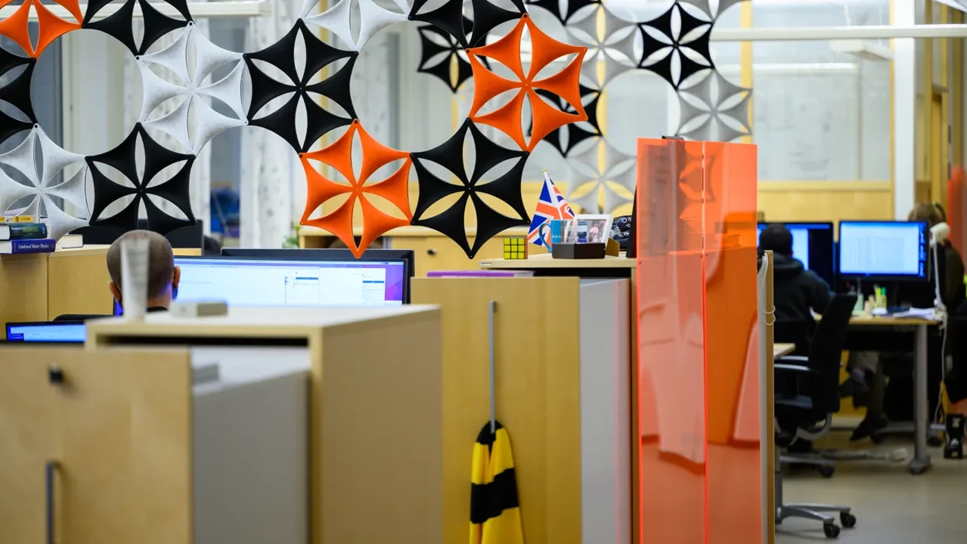 An office space with cubicles and air flakes hanging from the ceiling