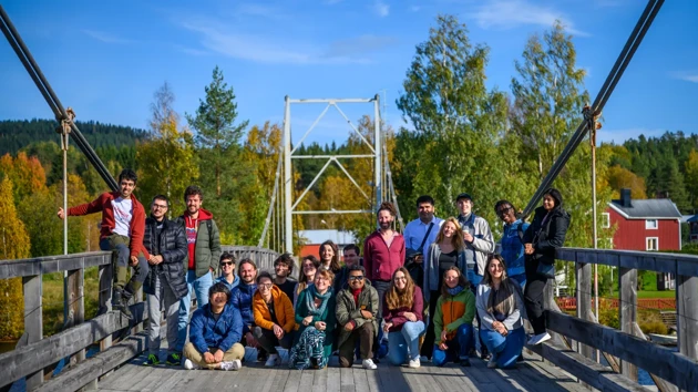 A group of people standing on a bridge