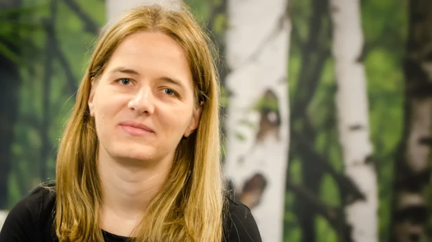 A woman in a black shirt looking at the camera