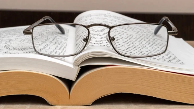 Reading glasses on an open book.