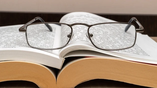 Reading glasses on an open book.