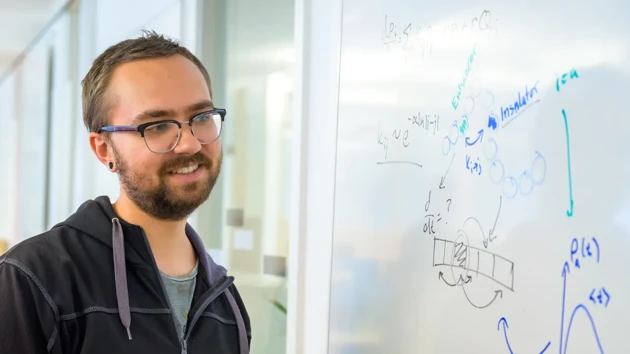 Lucas Hedström looks at a whiteboard