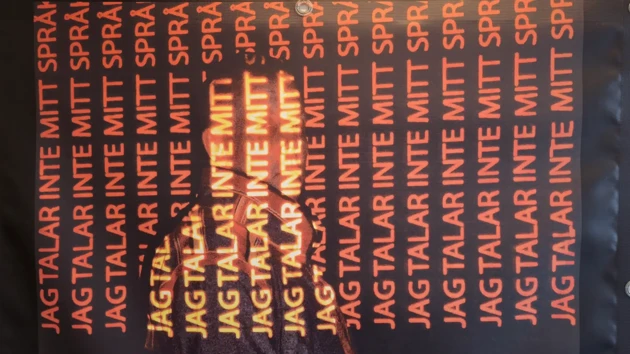 Poster with orange coloured text on black